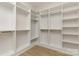 Bright walk-in closet with custom shelving and wood floor at 1025 Baylor Grv, Monroe, NC 28112