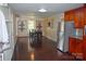 Spacious dining area with hardwood floors, a built-in shelving unit, and a kitchen view at 212 Pethel St, Kannapolis, NC 28081