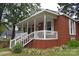 Brick home with a wraparound porch and white railings at 212 Pethel St, Kannapolis, NC 28081