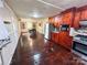 Open kitchen with wood cabinets, stainless steel appliances, and a dining area at 212 Pethel St, Kannapolis, NC 28081