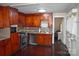 Kitchen with wood cabinets, stainless steel appliances and a view into the dining area at 212 Pethel St, Kannapolis, NC 28081