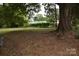 Spacious backyard with large trees and a partially visible fence at 212 Pethel St, Kannapolis, NC 28081