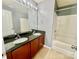 Bright bathroom featuring double vanity, granite countertops, and bath with shower at 4327 Kobuk Ln, Charlotte, NC 28269