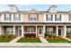 Inviting townhome exterior features a well-maintained lawn and classic architectural details at 4327 Kobuk Ln, Charlotte, NC 28269