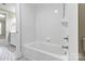 Bright bathroom showing a white tiled bathtub and shower combination at 5916 Bridger Ct, Charlotte, NC 28211