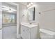 Bathroom featuring a white vanity with marble countertop, toilet, and a doorway to the bedroom at 5916 Bridger Ct, Charlotte, NC 28211