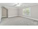 Spacious carpeted bedroom with a bright window and neutral paint at 5916 Bridger Ct, Charlotte, NC 28211
