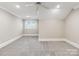 Bright bedroom featuring a large window, neutral walls, and plush gray carpet at 5916 Bridger Ct, Charlotte, NC 28211