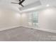 A light and airy bedroom features a neutral paint color and a large window at 5916 Bridger Ct, Charlotte, NC 28211