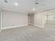 Spacious bedroom with neutral walls, ceiling fan, and doorway to an adjoining room at 5916 Bridger Ct, Charlotte, NC 28211