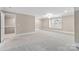 Large bonus room with neutral walls, carpet, and a window seat offers versatile living space at 5916 Bridger Ct, Charlotte, NC 28211