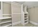 Walk-in closet with white shelves and rods for organizing clothes at 5916 Bridger Ct, Charlotte, NC 28211