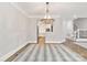 Elegant dining room with chandelier and hardwood floors adjacent to kitchen at 5916 Bridger Ct, Charlotte, NC 28211
