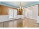Formal dining room with hardwood floors, wainscoting, and natural light offers an elegant ambiance at 5916 Bridger Ct, Charlotte, NC 28211