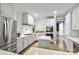 Modern kitchen features white cabinetry, stainless steel appliances, and a center island at 5916 Bridger Ct, Charlotte, NC 28211