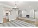 Open-concept living space features a fireplace, hardwood floors, and staircase at 5916 Bridger Ct, Charlotte, NC 28211