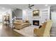 Cozy living room boasts a fireplace, built-in shelving, and staircase access at 5916 Bridger Ct, Charlotte, NC 28211