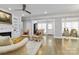 Open-concept living room with fireplace, hardwood floors, and a view to sunroom at 5916 Bridger Ct, Charlotte, NC 28211