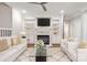 Bright living room boasts a fireplace, custom built-ins and plush seating at 5916 Bridger Ct, Charlotte, NC 28211