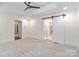 Spacious main bedroom featuring recessed lighting and a barn door leading to the main bathroom at 5916 Bridger Ct, Charlotte, NC 28211
