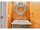 Elegant powder room featuring a marble countertop, a decorative mirror, and stylish fixtures at 5916 Bridger Ct, Charlotte, NC 28211