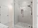 A clear glass shower features decorative tiles, a rainfall shower head, and bench seating at 5916 Bridger Ct, Charlotte, NC 28211