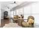 Bright sunroom with large windows, hardwood floors, and seating area at 5916 Bridger Ct, Charlotte, NC 28211