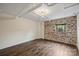 Bedroom with exposed brick wall and hardwood floors at 715 N Graham St # 201, Charlotte, NC 28202