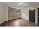 Bedroom featuring an exposed brick accent wall at 715 N Graham St # 201, Charlotte, NC 28202