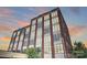Brick building exterior with many windows at sunset at 715 N Graham St # 201, Charlotte, NC 28202