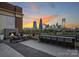 Relaxing rooftop terrace with city views, fireplace, and seating at 715 N Graham St # 201, Charlotte, NC 28202