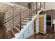 Stylish stairs with built-in storage and exposed brick feature wall at 715 N Graham St # 201, Charlotte, NC 28202