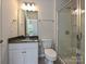 Bright bathroom features a walk-in shower, toilet, vanity, and natural light at 16725 Cozy Cove Rd, Charlotte, NC 28278