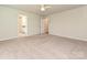 Neutral-colored bedroom with a ceiling fan and multiple doorways at 16725 Cozy Cove Rd, Charlotte, NC 28278