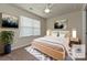 Cozy bedroom with natural light, neutral colors and a light wood bed frame at 16725 Cozy Cove Rd, Charlotte, NC 28278