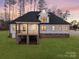 House with large deck and grassy backyard at dusk at 3001 Sparrow Springs Rd, Gastonia, NC 28052