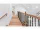 Bright hallway with wooden floors and black railing at 3001 Sparrow Springs Rd, Gastonia, NC 28052