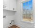 Laundry room with white cabinets and a large window with wooded views at 3001 Sparrow Springs Rd, Gastonia, NC 28052