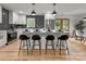 Contemporary kitchen with white island seating, stainless steel appliances, and stylish backsplash at 3317 Sargeant Dr, Charlotte, NC 28217