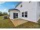 A back exterior view showcasing the home's patio and lawn at 203 Alden Ct, Shelby, NC 28152