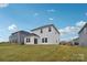 Backyard view of a two-story home with white siding and a well-maintained lawn at 203 Alden Ct, Shelby, NC 28152