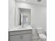 Modern bathroom features a large mirror, single sink vanity, and toilet at 203 Alden Ct, Shelby, NC 28152