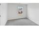 This bedroom features neutral carpeting and a window with neighborhood views at 203 Alden Ct, Shelby, NC 28152