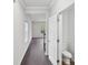 Hallway featuring hardwood floors and a partial bath, connecting various living spaces at 203 Alden Ct, Shelby, NC 28152