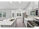 This open kitchen features modern white cabinets and stainless steel appliances at 203 Alden Ct, Shelby, NC 28152