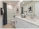 Modern bathroom featuring double sinks, white cabinets, and a shower with black and white curtains at 205 Alden Ct, Shelby, NC 28152