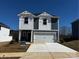 Charming two-story home featuring vertical siding, a two-car garage, and a well-manicured front lawn at 205 Alden Ct, Shelby, NC 28152