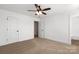 Bedroom featuring neutral walls, carpet, a closet, and a glimpse into the bathroom at 3000 Celia Ave, Charlotte, NC 28216