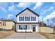 Two-story house with gray and white siding, a front porch, and a driveway at 3000 Celia Ave, Charlotte, NC 28216