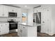 Bright kitchen showing stainless steel appliances, granite countertops, and white cabinets at 3000 Celia Ave, Charlotte, NC 28216